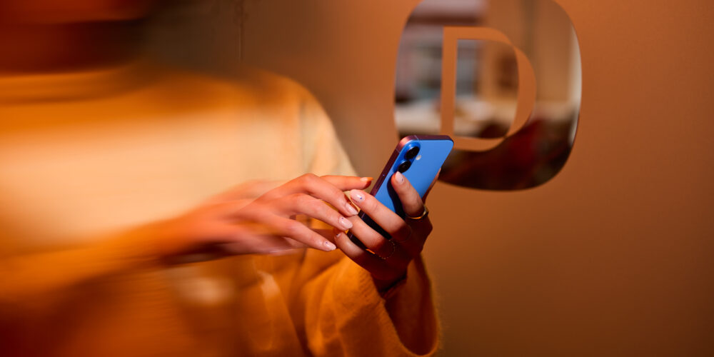 Hand holding iPhone Native vs Hybrid Whitepaper dawn technology
